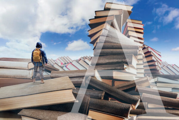 Person on stacks of huge books, with blue skies and white clouds. A large letter A overlays the image.