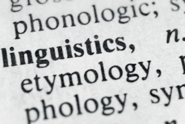 Dictionary page in close up, zoomed in on 'linguistics' in bold.